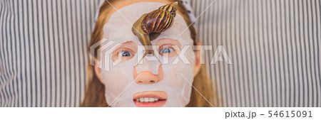 Young woman makes a face mask with snail mucus. Snail crawling on a face mask BANNER, LONG FORMAT Young woman makes a face mask with snail mucus. Snail crawling on a face mask BANNER, LONG FORMAT 54615091
