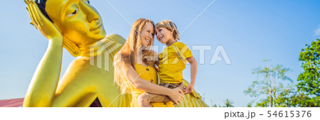 Happy tourists mother and son on background ofLying Buddha statue BANNER, LONG FORMAT Happy tourists mother and son on background ofLying Buddha statue BANNER, LONG FORMAT 54615376