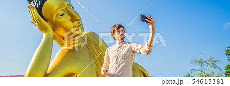 Happy man tourist on background ofLying Buddha statue BANNER, LONG FORMAT Happy man tourist on background ofLying Buddha statue BANNER, LONG FORMAT 54615381