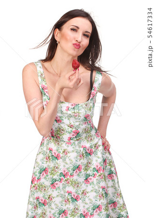 Closeup portrait of a young woman eating strawberry Closeup portrait of a young woman eating strawberry 54617334