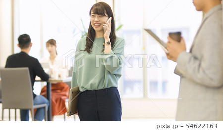 オフィスで電話を受ける女性 オフィスで電話を受ける女性 54622163