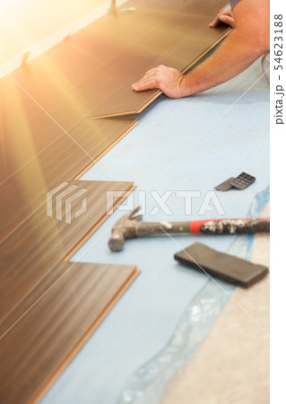 Man Installing New Laminate Wood Flooring 54623188