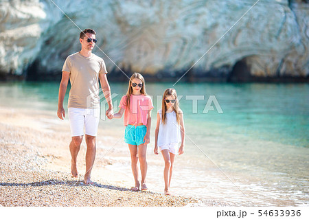 Happy beautiful family of dad and kids on white beach 54633936