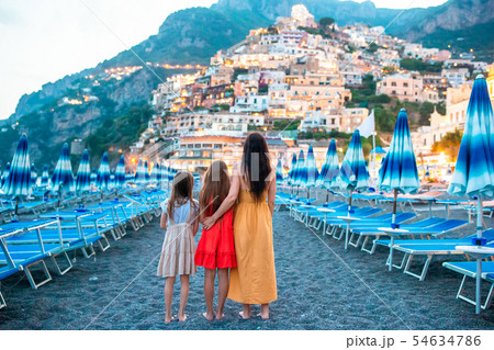 Family in front of Positano on the Amalfi coast in Italy in sunset 54634786