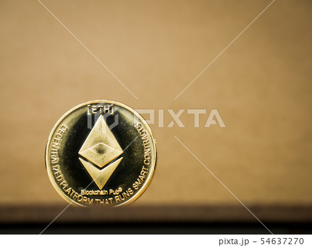 Ethereum coin on a brown background. 54637270