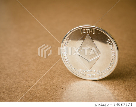 Ethereum coin on a brown background. Ethereum coin on a brown background. 54637271