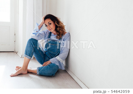 Portrait of a beautiful woman in a denim jumpsuit 54642059