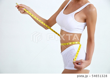 Young woman with beautiful body and measure tape 54651328
