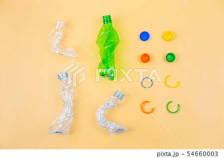 Crumpled plastic bottles and caps ready for recycl Crumpled plastic bottles and caps ready for recycl 54660003