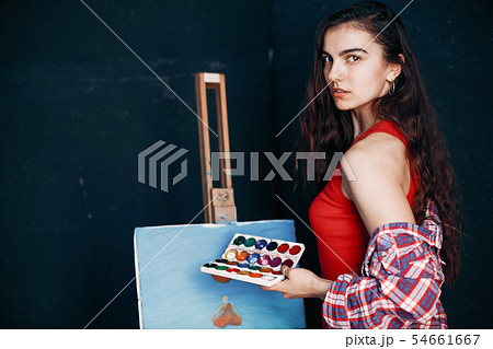 Elegant girl draws in an art studio 54661667