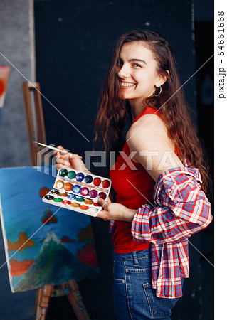 Elegant girl draws in an art studio Elegant girl draws in an art studio 54661668
