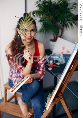 Elegant girl draws in an art studio Elegant girl draws in an art studio 54662452