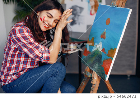 Elegant girl draws in an art studio Elegant girl draws in an art studio 54662473