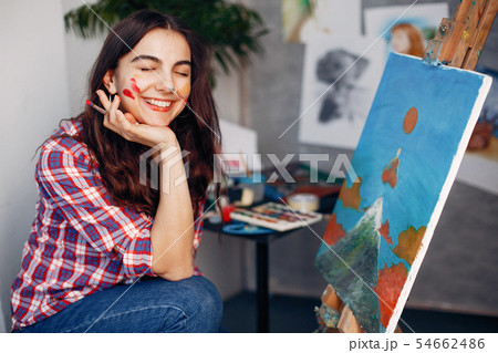 Elegant girl draws in an art studio Elegant girl draws in an art studio 54662486