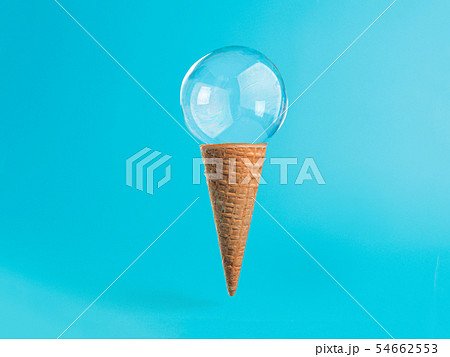 Ice cream cone with soap bubble on blue background Ice cream cone with soap bubble on blue background 54662553
