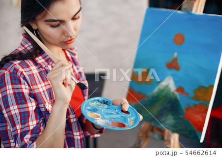 Elegant girl draws in an art studio Elegant girl draws in an art studio 54662614