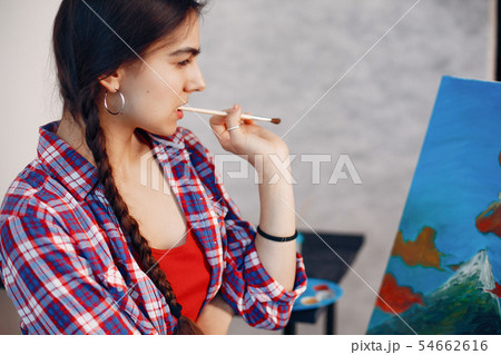 Elegant girl draws in an art studio Elegant girl draws in an art studio 54662616