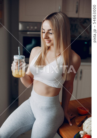 Sports girl in a kitchen with fruits Sports girl in a kitchen with fruits 54663000