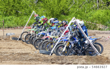 Motocross riders practice tricks on their dirt Motocross riders practice tricks on their dirt 54663927