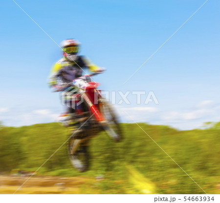 The blurry image of motorcycle rider during 54663934
