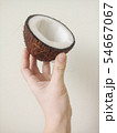 Hand holding sliced coconut 54667067