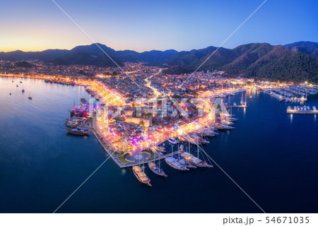 Aerial view of boats and beautiful city at night Aerial view of boats and beautiful city at night 54671035