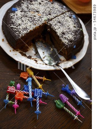 half-eaten birthday cake and extinguished candles half-eaten birthday cake and extinguished candles 54673989