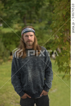 profile portrait of a young man with long hair and 54674510
