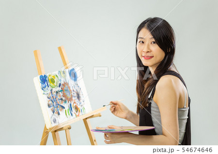 Artist holding painting palette and brush 54674646