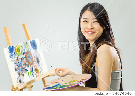 Artist holding painting palette and brush Artist holding painting palette and brush 54674649