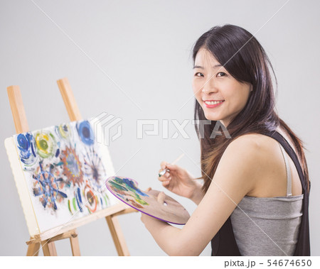 Artist holding painting palette and brush Artist holding painting palette and brush 54674650