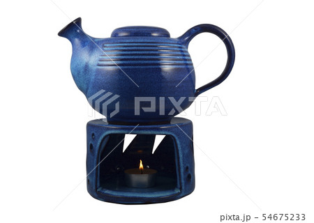 blue ceramic teapot with a candle heated on a blue ceramic teapot with a candle heated on a 54675233