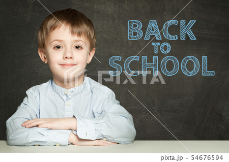 Back to school text and happy kid on chalkboard 54676594