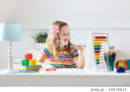 Child with abacus doing homework after school. Child with abacus doing homework after school. 54676615
