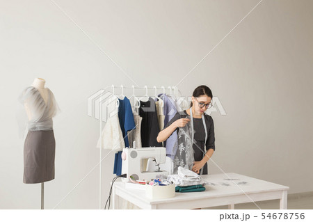 Dressmaker, fashion designer and tailor concept - Fashion designer woman working in the studio 54678756