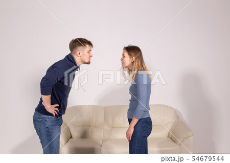 people, home violence and abuse concept - young couple screaming to each other people, home violence and abuse concept - young couple screaming to each other 54679544