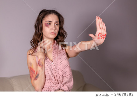 Domestic violence, protesting and people concept - brunette woman expressing denial with STOP on her 54679595