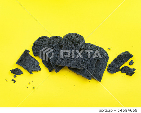 Organic bio charcoal bread on yellow background 54684669