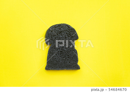 Organic bio charcoal bread on yellow background Organic bio charcoal bread on yellow background 54684670