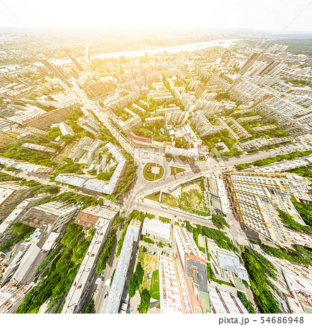 Aerial city view with crossroads and roads, houses, buildings, parks and parking lots. Sunny summer Aerial city view with crossroads and roads, houses, buildings, parks and parking lots. Sunny summer 54686948