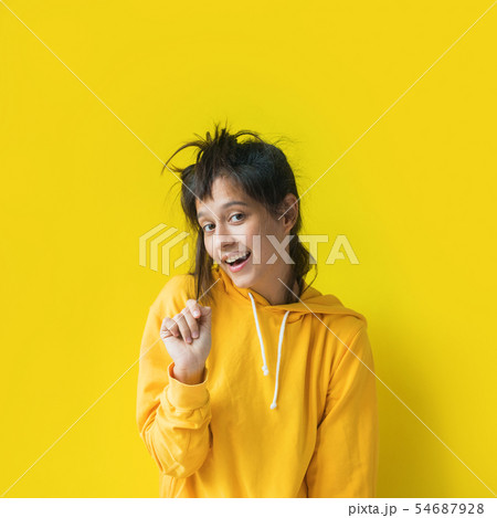Funny girl yellow hood sweatshirt pose emotionally 54687928