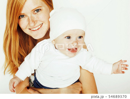 young beauty mother with cute baby, red head happy modern family smiling isolated on white 54689370