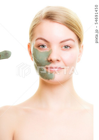 Skin care. Woman applying clay mud mask on face. Skin care. Woman applying clay mud mask on face. 54691450