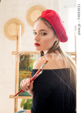 Attractive artist girl with long hair in red beret Attractive artist girl with long hair in red beret 54693631