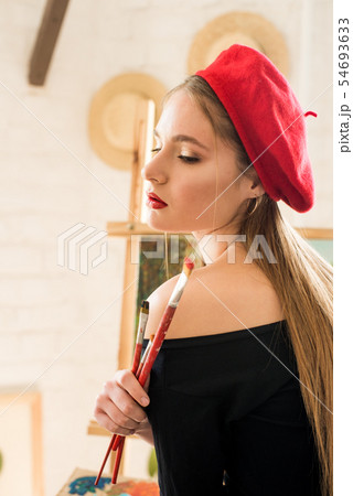 Attractive artist girl with long hair in red beret Attractive artist girl with long hair in red beret 54693633
