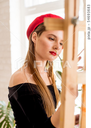 Attractive artist girl with long hair in red beret 54693683