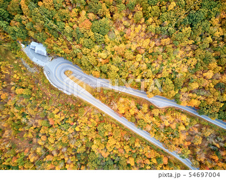 Scenic highway hairpin turn in autumn 54697004