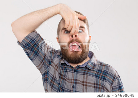 Handsome man shows crazy silly grimace or facial expression, isolated on white background. Making Handsome man shows crazy silly grimace or facial expression, isolated on white background. Making 54698049