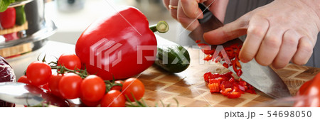Male Hands Slicing Red Organic Pepper Ingredient Male Hands Slicing Red Organic Pepper Ingredient 54698050