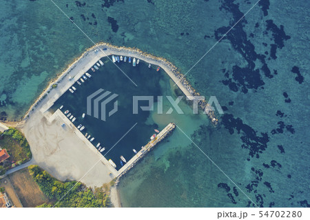 Aerial view of a bay port with boats on blue clear Aerial view of a bay port with boats on blue clear 54702280